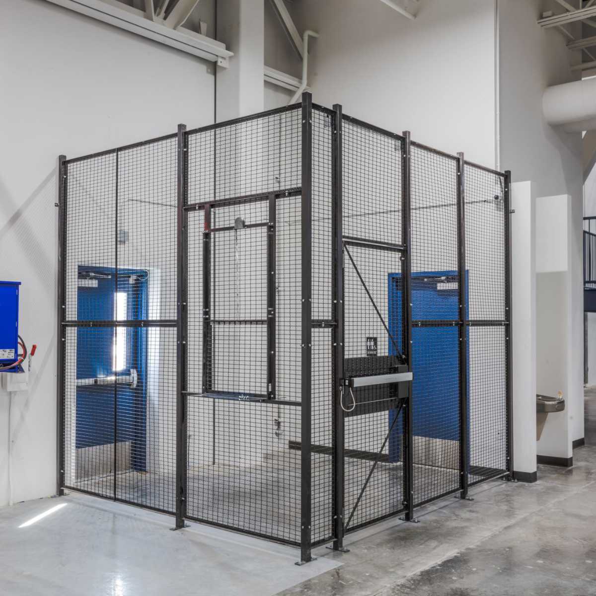 grey two-panel driver cage against building entrance