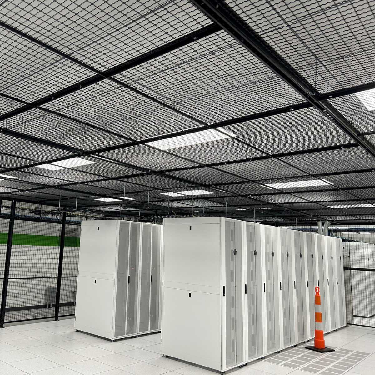 server racks inside black mesh cage with ceiling