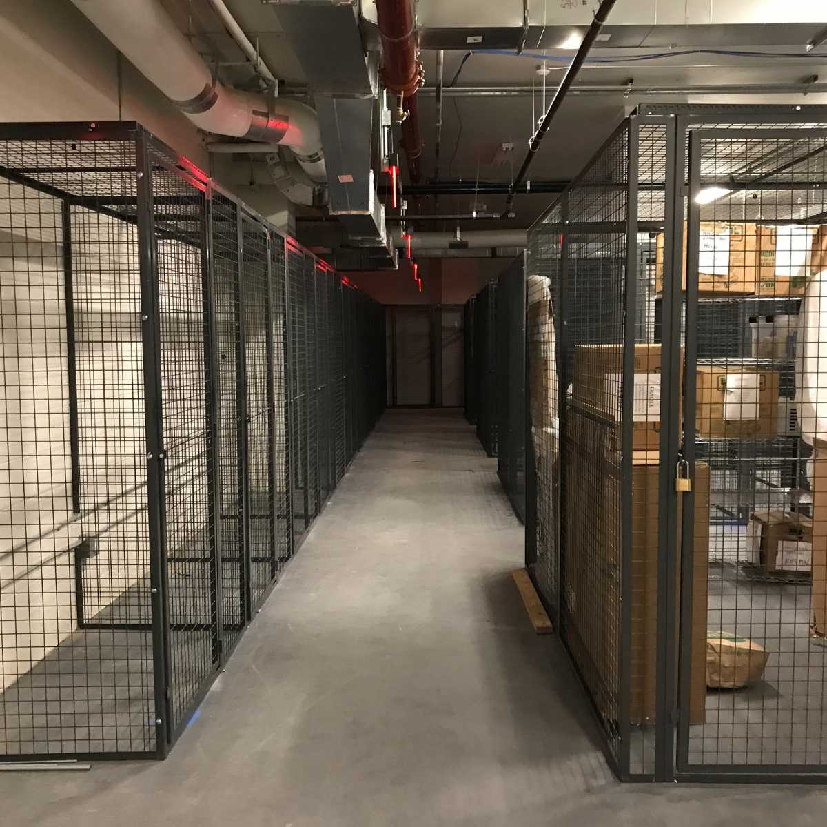 row of black wire mesh storage units